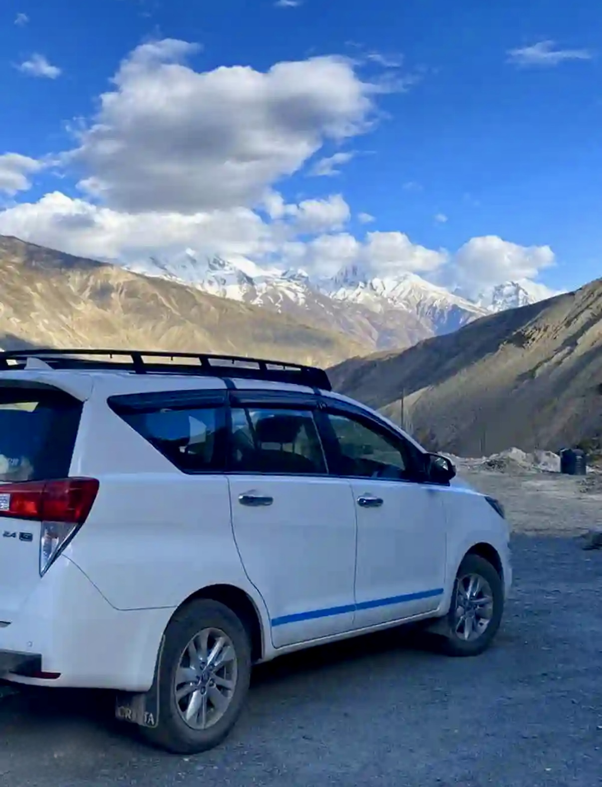 Innova Crysta cab with snow peaks in Uttarakhand